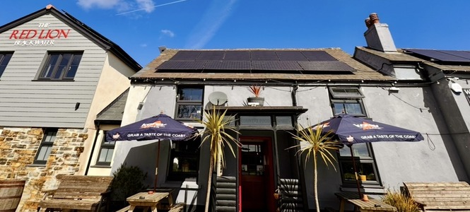 The Red Lion entrance with outdoor seating